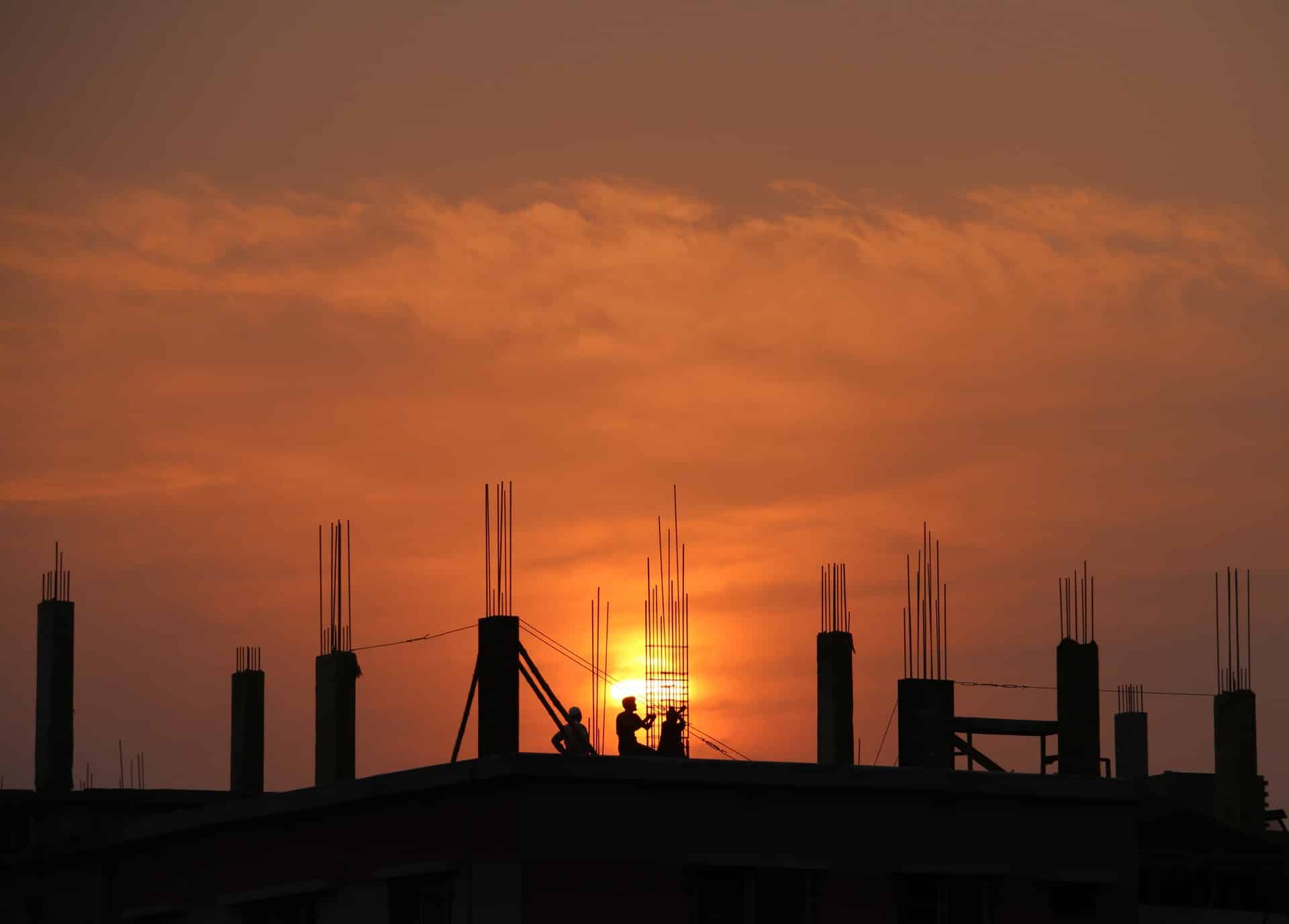 The sun is setting behind a tech construction site.