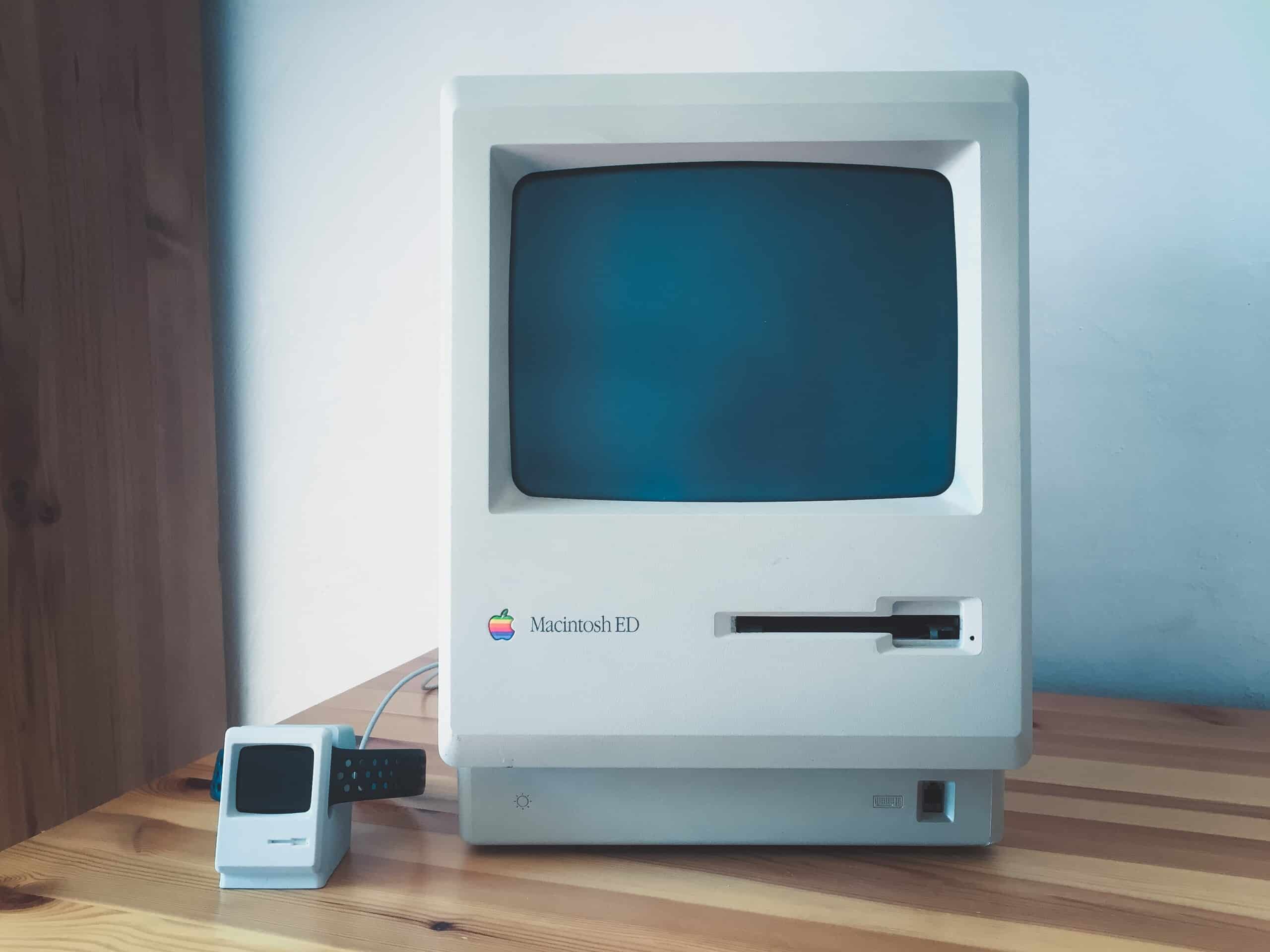 An innovative Apple Macintosh computer sitting on a wooden table.