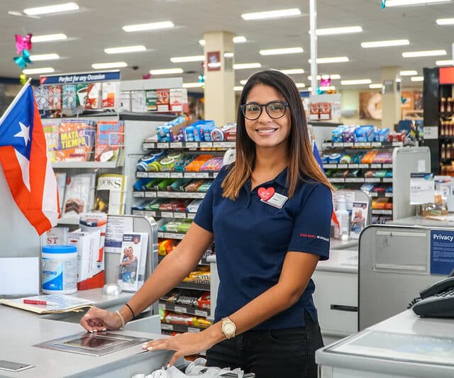 A woman standing at the register in a global store.