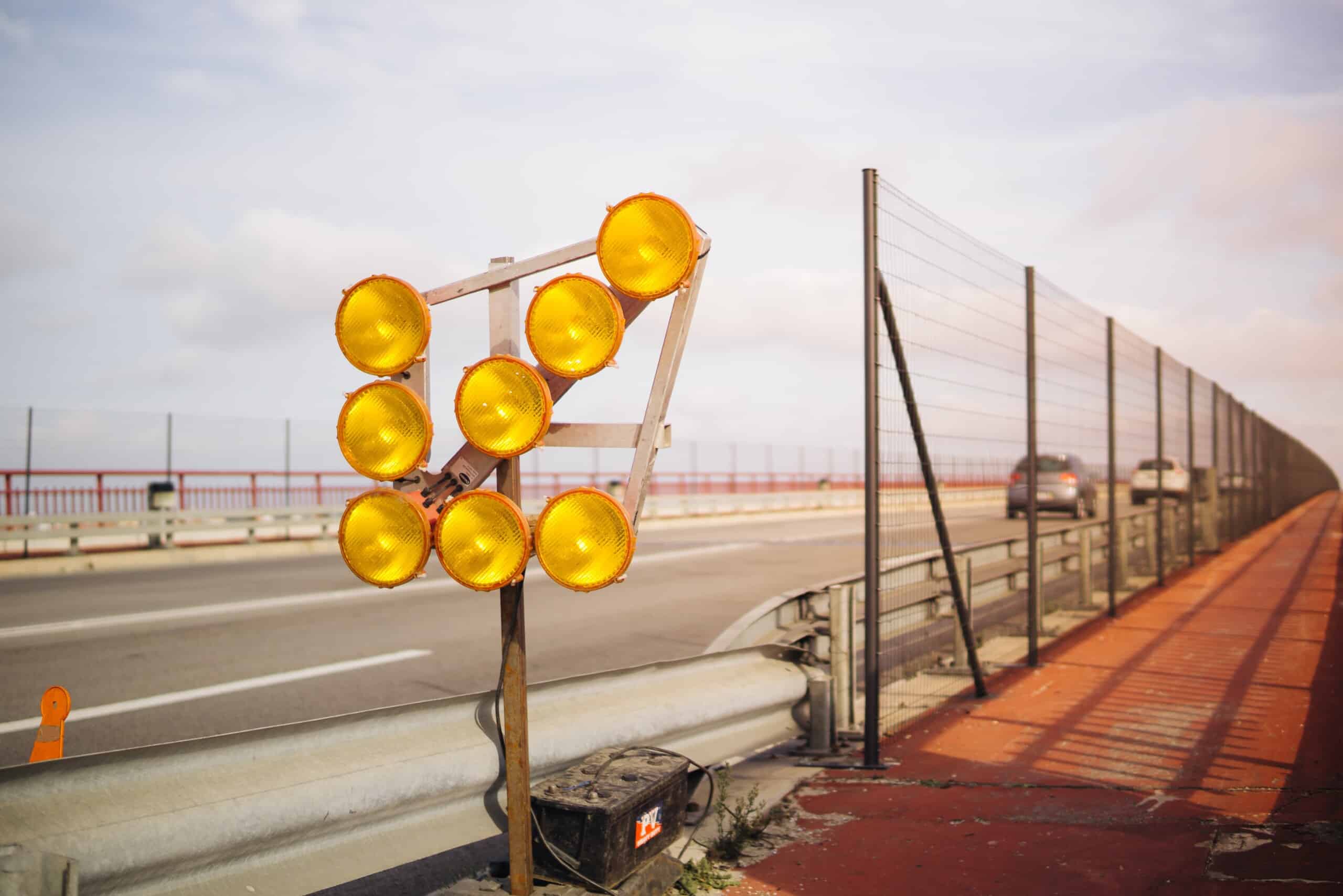 A global company has installed yellow traffic lights on the side of a road.