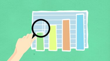 A hand holding a magnifying glass over a globally innovative graph consulting.