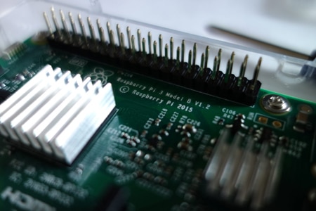 A close up image of a raspberry pi board, showcasing its strategic functionality.