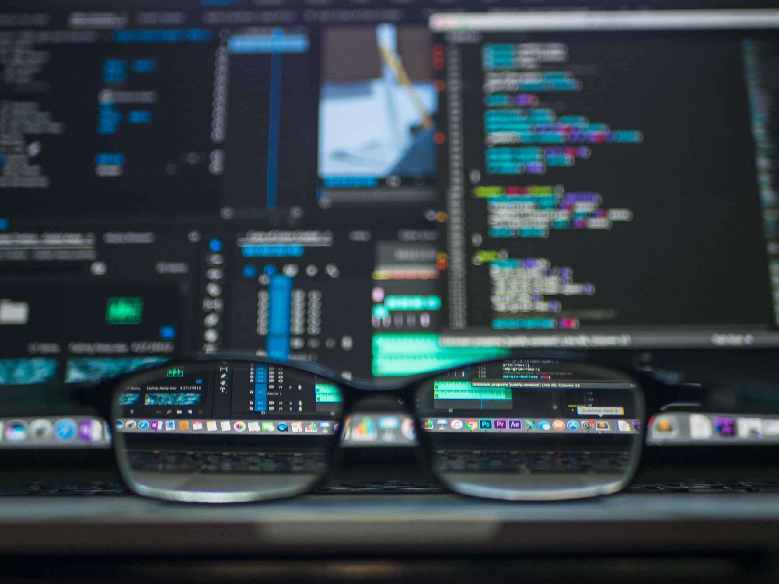 A pair of glasses sitting on top of a computer screen in a global company.