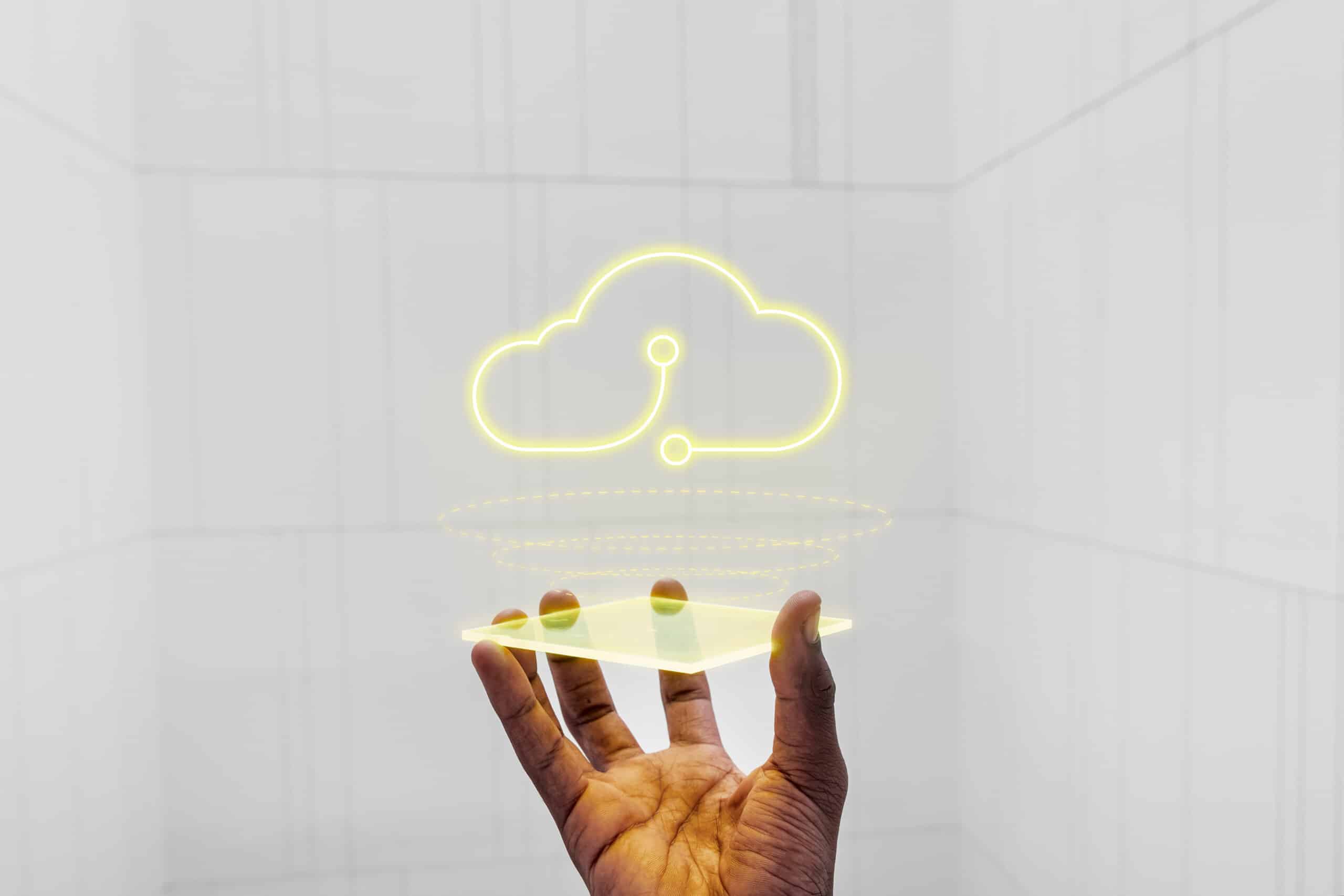 A man's hand is holding a cloud in front of it, showcasing the intersection of technology and global consulting.