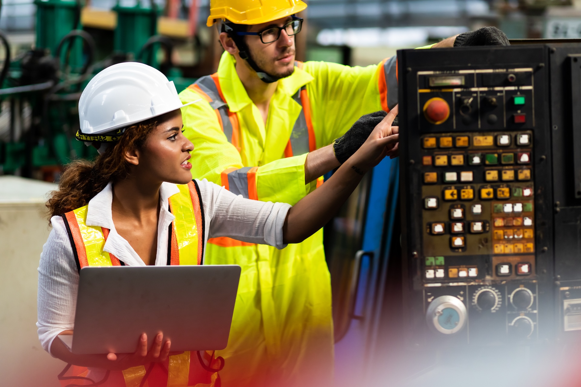 female Mechanical Engineer Works on Personal Computer and worker mehcanic man working at Metal lathe industrial manufacturing factory. Professional Engineer team Operating lathe Machinery